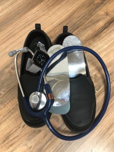 Shoes pictured with Featherspring Foot Supports and a watch and stethoscope.